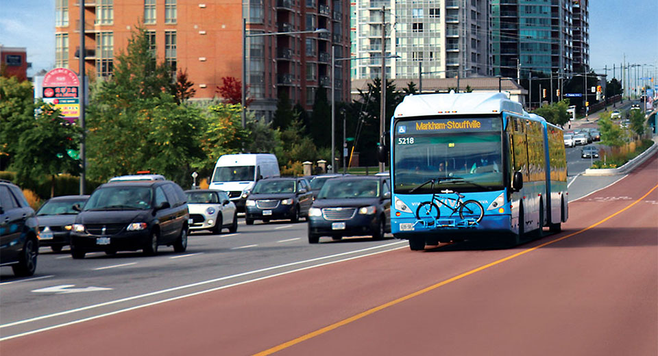 A viva bus travelling in an open bus lane while car wait in traffic.